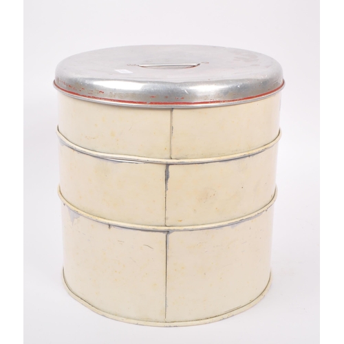 250 - A large mid Century three tiered cake tin of circular form having cream ground with silver lid and r... 