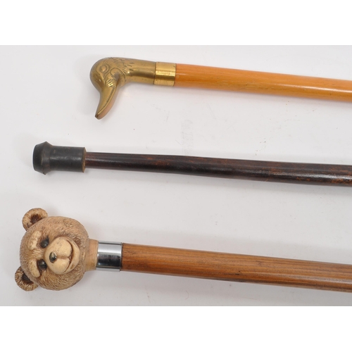 251 - A collection of five mid 20th century walking sticks. The collection to include an Italian Cavagnini... 