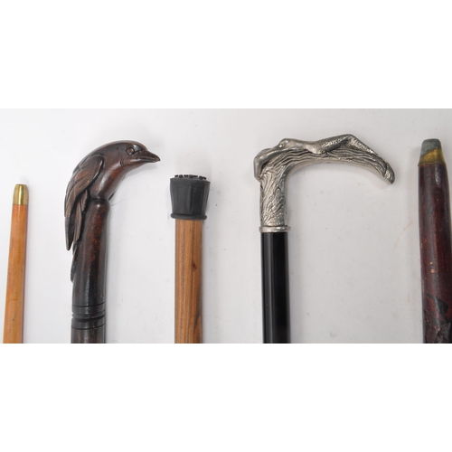 251 - A collection of five mid 20th century walking sticks. The collection to include an Italian Cavagnini... 
