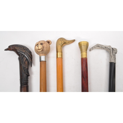 251 - A collection of five mid 20th century walking sticks. The collection to include an Italian Cavagnini... 