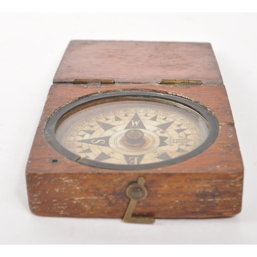 257 - A 19th century Victorian traveling compass. Mahogany case with hinged lid, and glass circular window... 