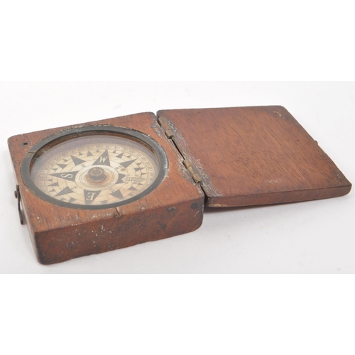 257 - A 19th century Victorian traveling compass. Mahogany case with hinged lid, and glass circular window... 