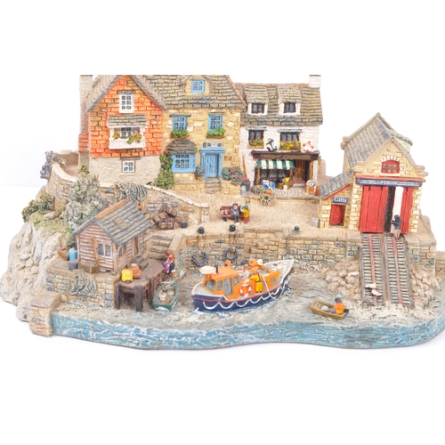 259 - Danbury Mint - A collection of eight Danbury Mint scenic models to include items from the The RNLI C... 