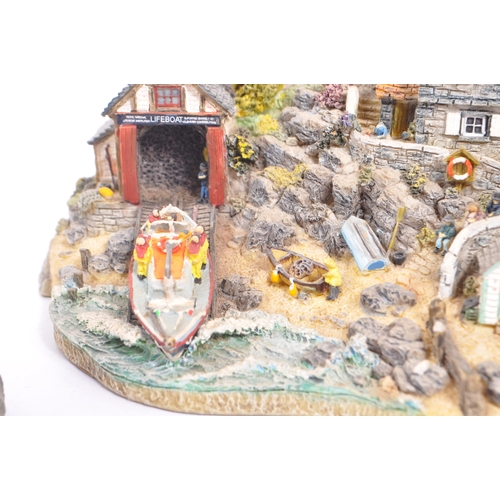 259 - Danbury Mint - A collection of eight Danbury Mint scenic models to include items from the The RNLI C... 