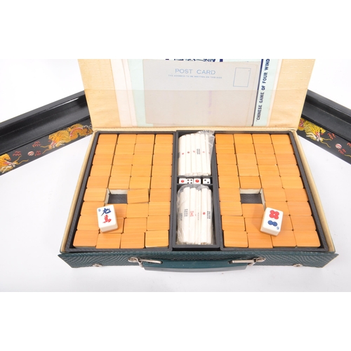 262 - A vintage 20th century mahjong set complete in a green vinyl case with four tile racks. Tiles of a p... 