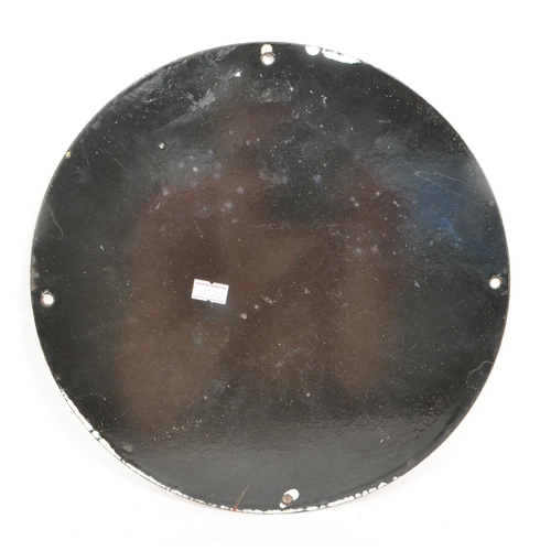 263 - An enamel sign of circular form, picturing a woman sat on a stall holding a phone with the slogan 