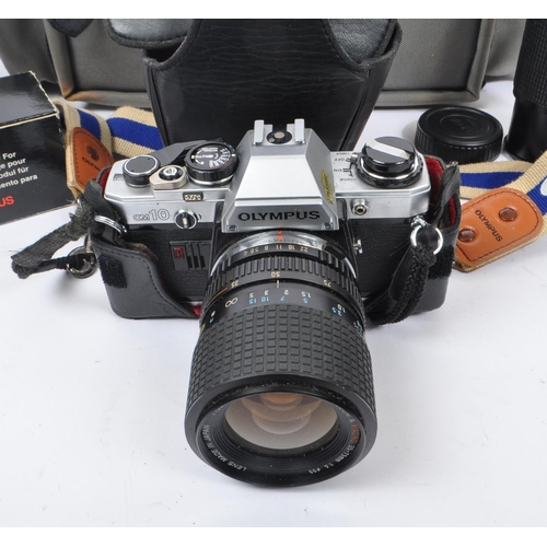265 - Olympus - A late 20th century circa 1980s Olympus OM10 35mm SLR camera and accessories. The camera i... 