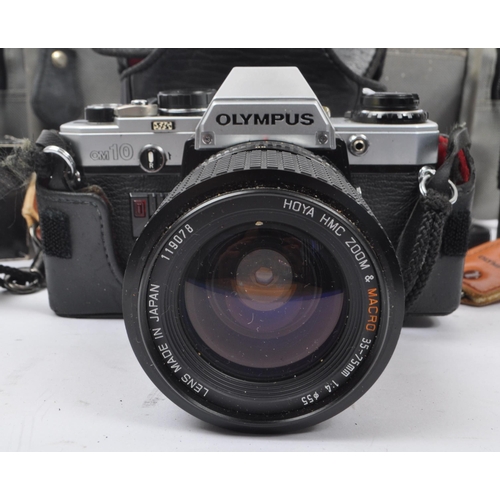 265 - Olympus - A late 20th century circa 1980s Olympus OM10 35mm SLR camera and accessories. The camera i... 