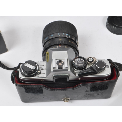 265 - Olympus - A late 20th century circa 1980s Olympus OM10 35mm SLR camera and accessories. The camera i... 