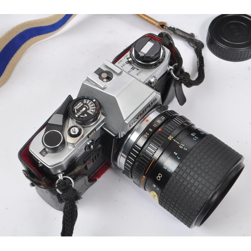 265 - Olympus - A late 20th century circa 1980s Olympus OM10 35mm SLR camera and accessories. The camera i... 