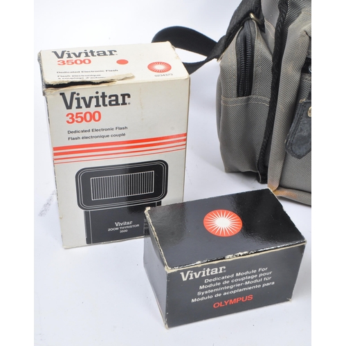 265 - Olympus - A late 20th century circa 1980s Olympus OM10 35mm SLR camera and accessories. The camera i... 