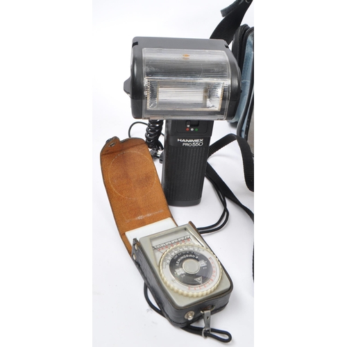266 - Canon - A late 20th century 1980s Canon T70 35mm SLR camera with Hanimex Pro 550 electronic flash an... 