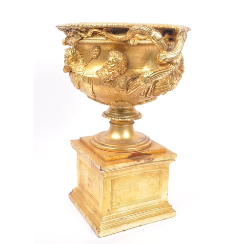 268 - A large gilt twin handled Warwick cup / vase / urn having gold relief Roman portrait imagery and kno... 