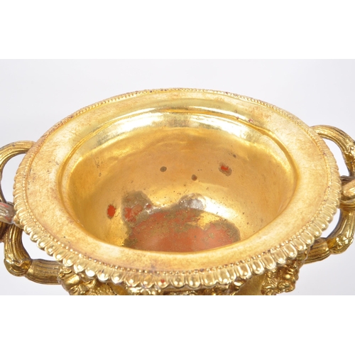 268 - A large gilt twin handled Warwick cup / vase / urn having gold relief Roman portrait imagery and kno... 