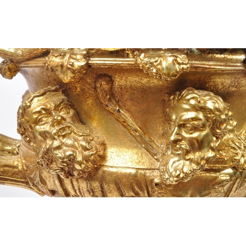 268 - A large gilt twin handled Warwick cup / vase / urn having gold relief Roman portrait imagery and kno... 