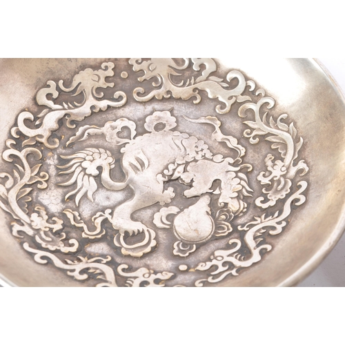 274 - A pair of Chinese Baitong metal plates. Each plate of rounded form with repousse dragon motifs to ce... 