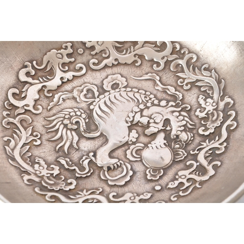 274 - A pair of Chinese Baitong metal plates. Each plate of rounded form with repousse dragon motifs to ce... 