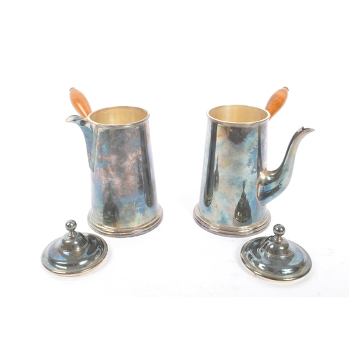 275 - Roberts & Belk Ltd - A pair of early 20th Century silver plated coffee / hot chocolate pots having w... 