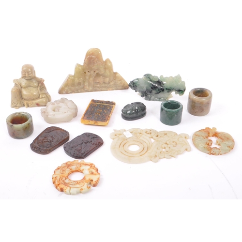 277 - A collection of fifteen Chinese jade and soapstone curios. The collection to include a carved Buddha... 