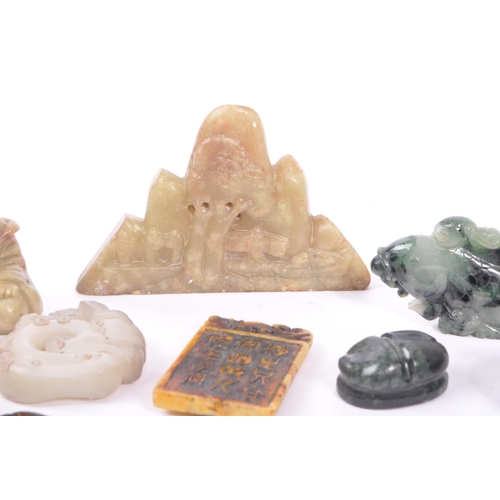 277 - A collection of fifteen Chinese jade and soapstone curios. The collection to include a carved Buddha... 