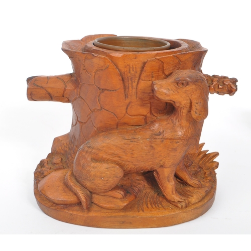 285 - A collection of wooden items to include a black forest candle holder in the form of a dog's head wit... 
