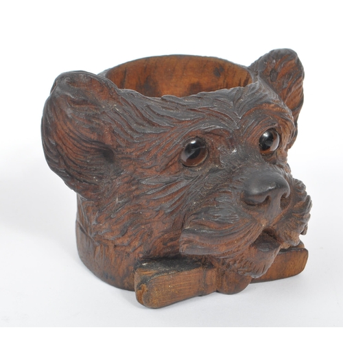 285 - A collection of wooden items to include a black forest candle holder in the form of a dog's head wit... 