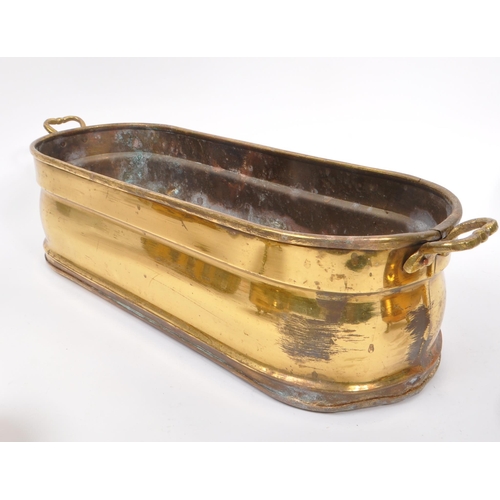 288 - A late 19th Century Victorian brass planter of ovoid form with twin handles to either side with roun... 