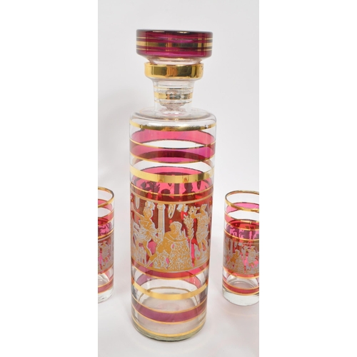 29 - A vintage 20th century circa 1970s gilt and cranberry drinking decanter and glass set. With circular... 