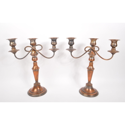 293 - A 20th Century claret jug having cut glass body and silver plated top with flourishes to handle. Tog... 