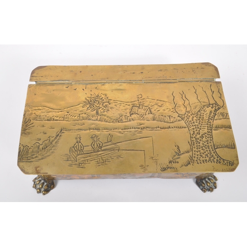 298 - A 19th century Dutch brass tobacco tin / box. The box raised on paw feet to front, with lions head r... 