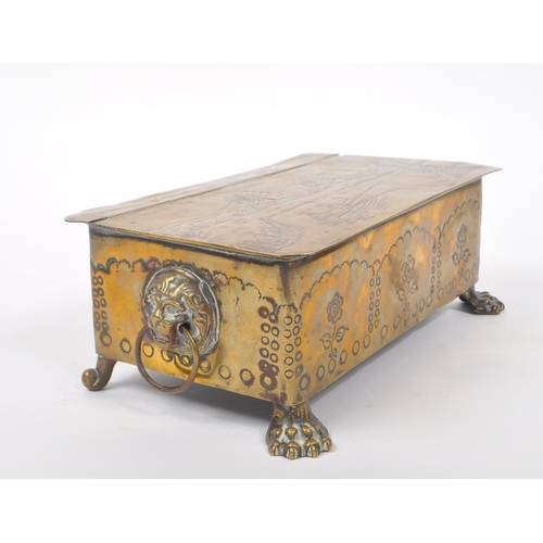 298 - A 19th century Dutch brass tobacco tin / box. The box raised on paw feet to front, with lions head r... 
