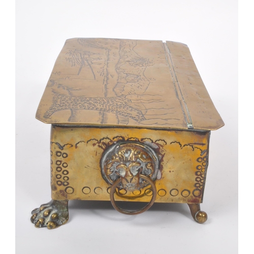 298 - A 19th century Dutch brass tobacco tin / box. The box raised on paw feet to front, with lions head r... 