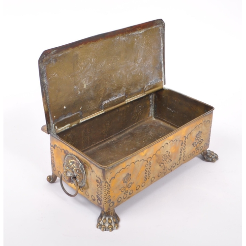 298 - A 19th century Dutch brass tobacco tin / box. The box raised on paw feet to front, with lions head r... 