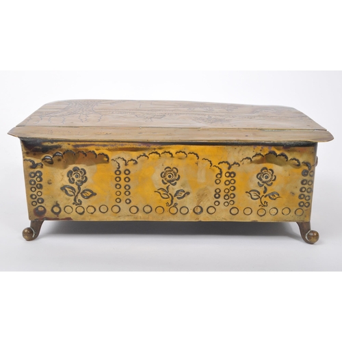 298 - A 19th century Dutch brass tobacco tin / box. The box raised on paw feet to front, with lions head r... 