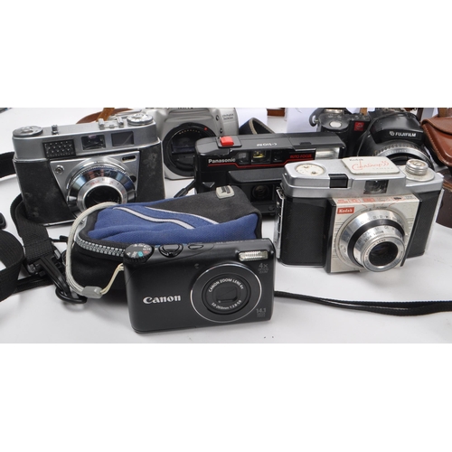 338 - A large collection of 20th century and contemporary cameras. The collection to include both film and... 