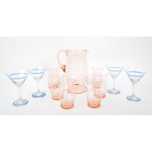 34 - A mid 20th century circa 1950s coloured glass lemonade set, alongside four cocktail glasses. The col... 