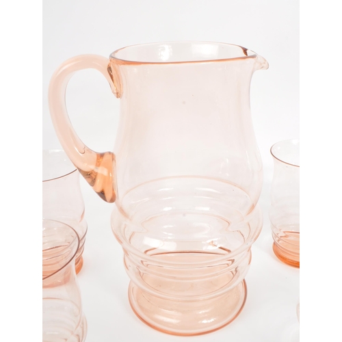 34 - A mid 20th century circa 1950s coloured glass lemonade set, alongside four cocktail glasses. The col... 