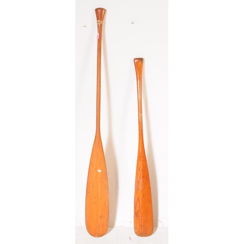 340 - Boating Interest - Two 20th century wooden boat paddles / oars. Each having shaped handles to top, w... 