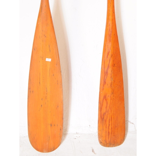 340 - Boating Interest - Two 20th century wooden boat paddles / oars. Each having shaped handles to top, w... 