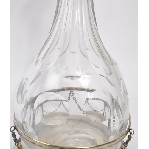 37 - A vintage 20th century faceted glass wine / brandy decanter. With a circular silver plate stand, wit... 