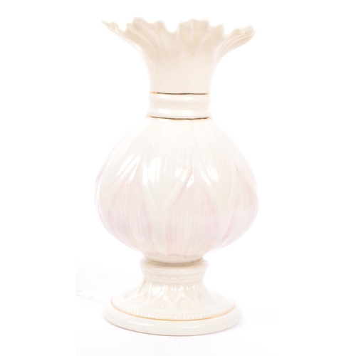 43 - Belleek - A 20th century Belleek Lotus vase, alongside a shell vase. The vase raised on a rounded ba... 