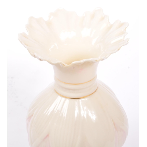 43 - Belleek - A 20th century Belleek Lotus vase, alongside a shell vase. The vase raised on a rounded ba... 