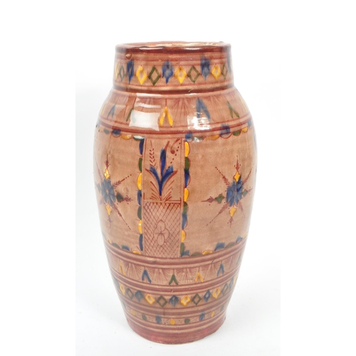 83 - A 20th century Moroccan Safi manner studio pottery terracotta vase. The vase having rounded body, ta... 