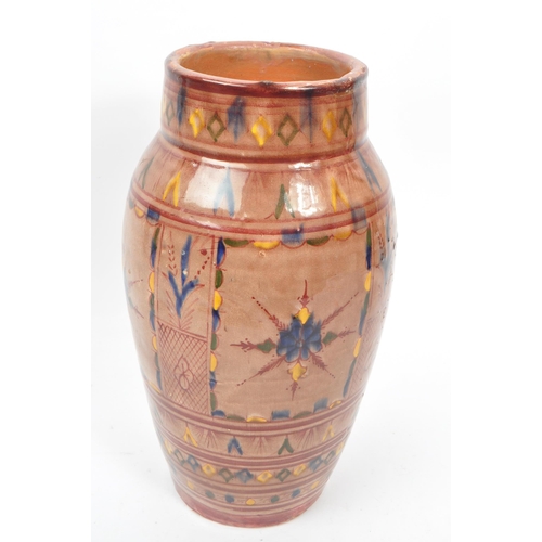 83 - A 20th century Moroccan Safi manner studio pottery terracotta vase. The vase having rounded body, ta... 