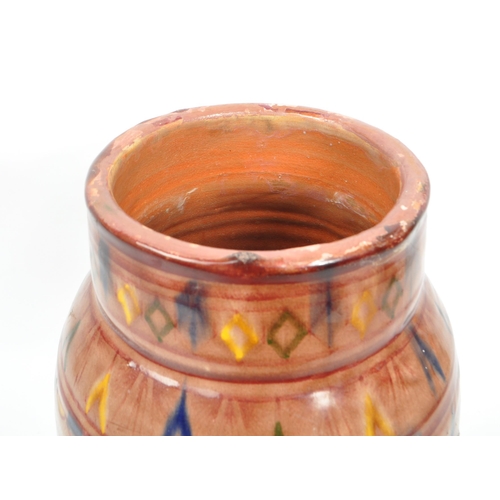 83 - A 20th century Moroccan Safi manner studio pottery terracotta vase. The vase having rounded body, ta... 