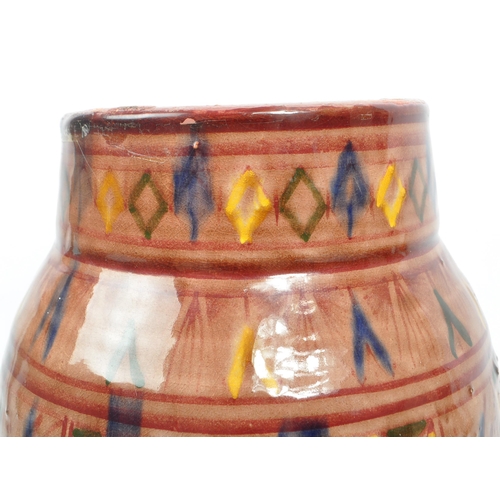 83 - A 20th century Moroccan Safi manner studio pottery terracotta vase. The vase having rounded body, ta... 