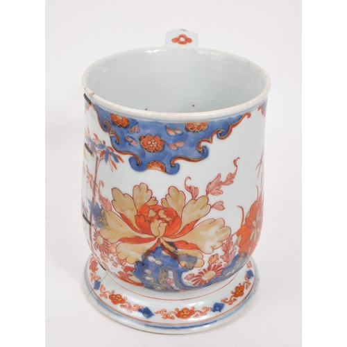 99 - A 17th century Kangxi period Chinese porcelain tankard / mug. With hand painted body in the red and ... 