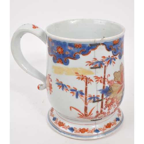 99 - A 17th century Kangxi period Chinese porcelain tankard / mug. With hand painted body in the red and ... 