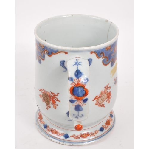 99 - A 17th century Kangxi period Chinese porcelain tankard / mug. With hand painted body in the red and ... 