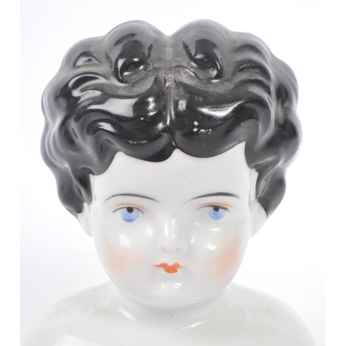 175 - An early 20th Century Art Deco china porcelain dolls head and shoulders, having hand painted feature... 